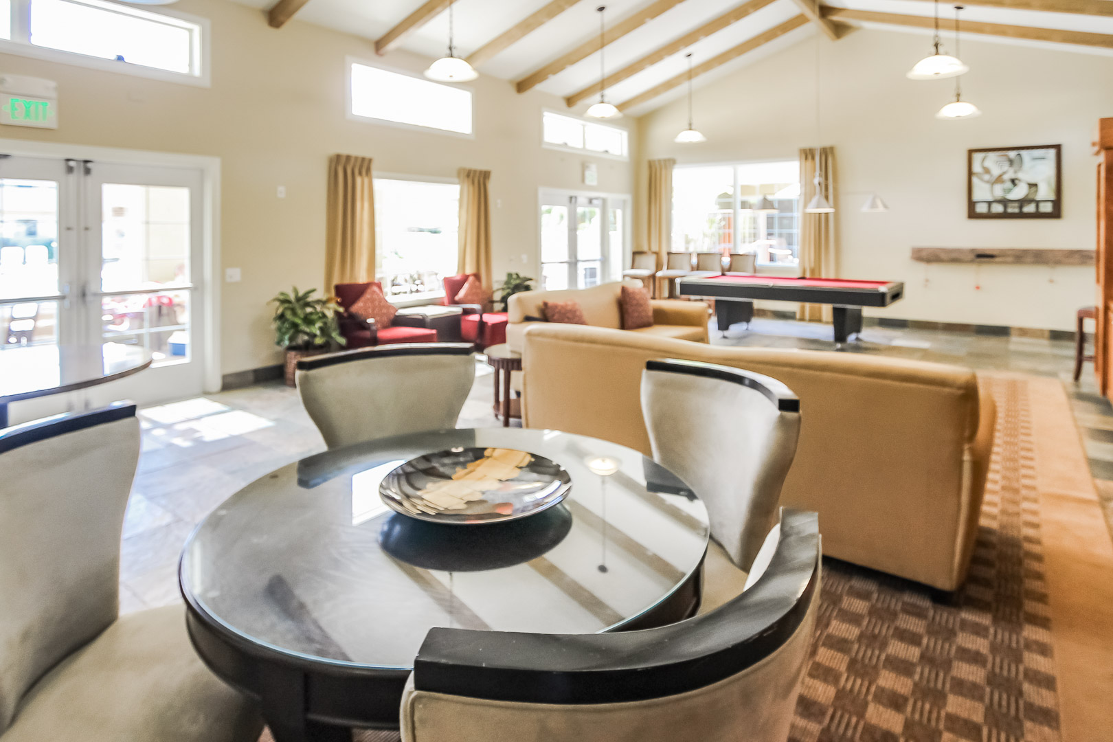 A pool table and lounging area at VRI's Winner Circle Resort in California.